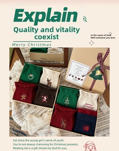 Detail of Christmas cotton socks gift box with reindeer embroidery and festive ribbons