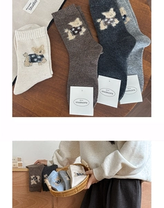 Close-up of wool crew socks with cute cartoon dog embroidery in various warm colors