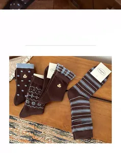 Detail of four pairs of warm winter cotton socks with cute dog embroidery and patterns