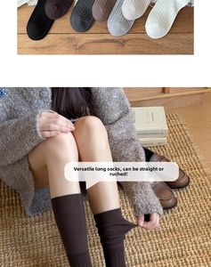 Close-up of ribbed knit thigh-high socks in multiple colors with cozy ballet style