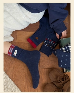 Detail of cozy navy blue winter crew socks featuring cute bear embroidery and stripes