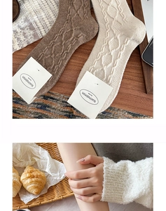 Detailed knit texture of wool-blend crew socks in beige and light brown tones