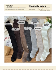 Flat lay of ribbed knit over-the-knee socks in multiple warm winter colors and textures
