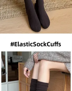 Detail of elastic cuff on dark brown ribbed knit ballet style knee-high socks