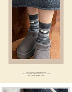 Close-up of grey striped wool socks with boots on warm wooden floor texture