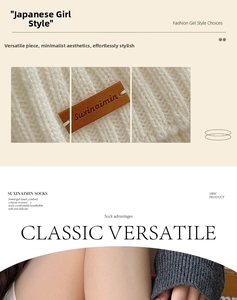 Close-up of white knitted leg warmer with a brown leather logo label and ribbed texture