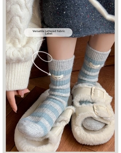 Close-up of striped wool socks with I dig you woven label detail for women