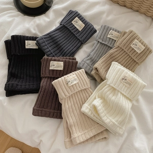 Cozy ribbed knit leg warmers in six neutral colors with stylish woven brand labels