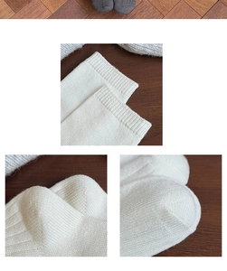 Close-up of white knitted over-the-knee socks showing ribbed cuffs and detailed stitching