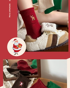 Macro view showing festive embroidery details of reindeer and Santa on cotton socks