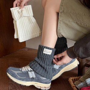 Winter JK knitted leg warmers in white and grey with stylish Somtimes fabric label