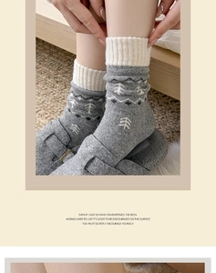 Detail of grey Fair Isle wool socks with white pine tree patterns and ribbed cuffs