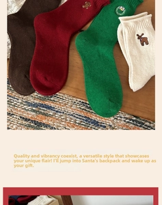 Detail shot of four Christmas socks with festive embroidery on a rustic vintage background