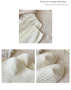 Detailed view of cream rib-knit mid-calf socks showing toe and heel craftsmanship