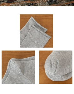 Detailaufnahmen grauer Stricksocken mit Rollbündchen, Fersenstich und nahtlosem Zehenbereich