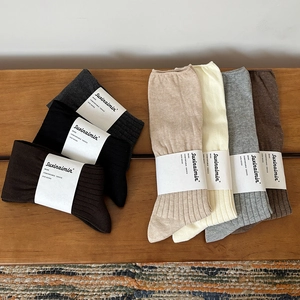 Minimalist solid color ribbed crew socks set in neutral earth tones with paper packaging