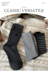 Détail de trois paires de chaussettes en coton gris avec broderie ours et texture côtelée