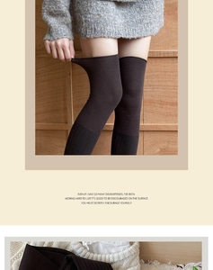 Close-up of black thigh high knitted socks showing elastic fabric texture and fit