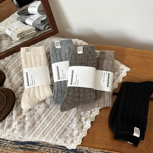 Cozy wool blend ribbed crew socks in neutral tones with vintage brand labels for women