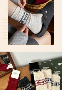 Detailed knit of thick wool socks with Nordic reindeer patterns and winter snowflake motifs