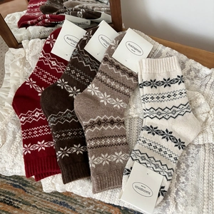 Set of four wool blend socks with vintage Nordic snowflake patterns for winter warmth