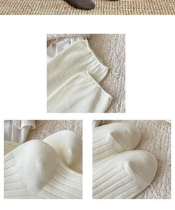 Detail of cream white ribbed texture and reinforced stitching on knitted long socks