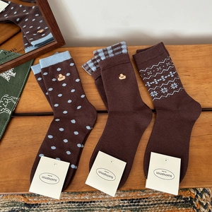 Three pairs of brown knit mid-tube socks with dog embroidery and polka dot patterns