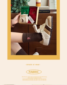 Detailed view of Christmas socks with embroidery and festive gift box packaging