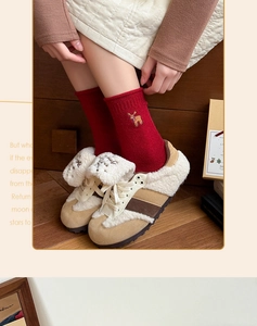 Close-up of festive Christmas socks with deer embroidery and warm winter boots