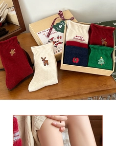 Detailed view of Christmas socks gift box with festive embroidery and plaid ribbon decor