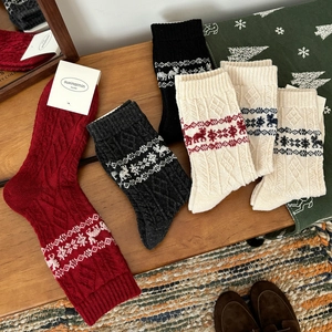 Fair Isle wool blend socks featuring festive reindeer patterns and cable knit texture