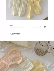 Detail of cable knit crew socks in pastel colors with decorative ruffled cuffs