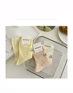 Detail of combed cotton hollow out mesh socks with lace trim and sweet bows in a basket