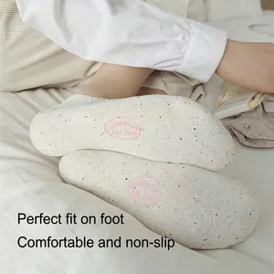 Japanese style cream cotton liner socks with pink embroidery on white bedding background