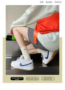 Detail showing beige ribbed cotton mid-calf socks with Suxin lettering on the ankle