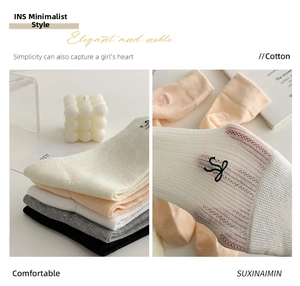 Close-up of cotton mesh socks with delicate letter embroidery in various pastel colors