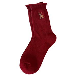 Festive dark red knitted wool Christmas socks with reindeer embroidery in high detail