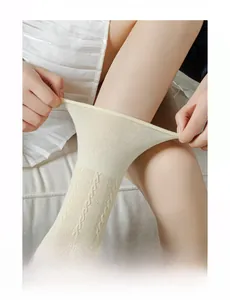 Detail showing high-stretch knit texture and beige cable pattern on knee-high socks