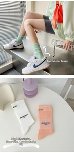 Detail of high-elastic ribbed cotton socks in pastel colors with letter print