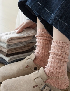 Detailed knit texture of vintage wool crew socks with colorful flecks and ribbed patterns