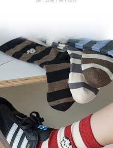 Detailed shot of striped cotton mid-calf socks featuring cute cartoon dog embroidery