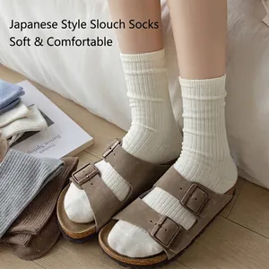 Japanese style off-white ribbed cotton slouch socks styled with brown suede sandals