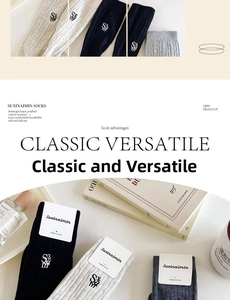Detailed view of combed cotton crew socks featuring fine ribbing and side letter embroidery
