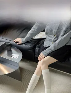 Detail of cream white knit calf socks with vertical ribbed texture for women