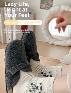 Detail of grey felt mule slippers with metal buckle and panda pattern cotton socks