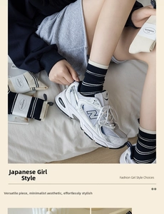 Detailed view of black mid-calf socks with white stripes and casual sports shoe styling