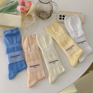 Pastel color cable knit mid-calf socks with ruffled cuffs and aesthetic props