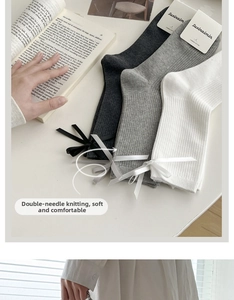 Detail of JK style combed cotton crew socks featuring silk ribbons and ribbed texture