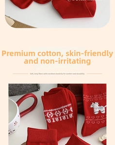 Close-up of red festive cotton socks with white reindeer patterns and ribbed cuffs