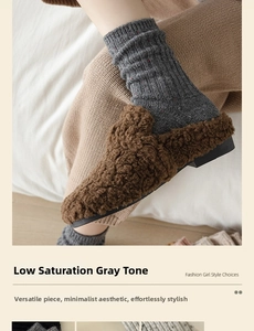 Close-up of cozy grey speckled wool socks paired with stylish brown faux fur loafers